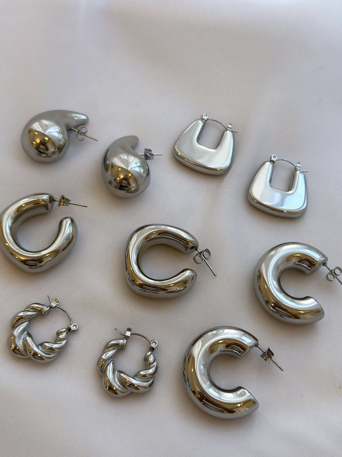 Silver twisted hoops